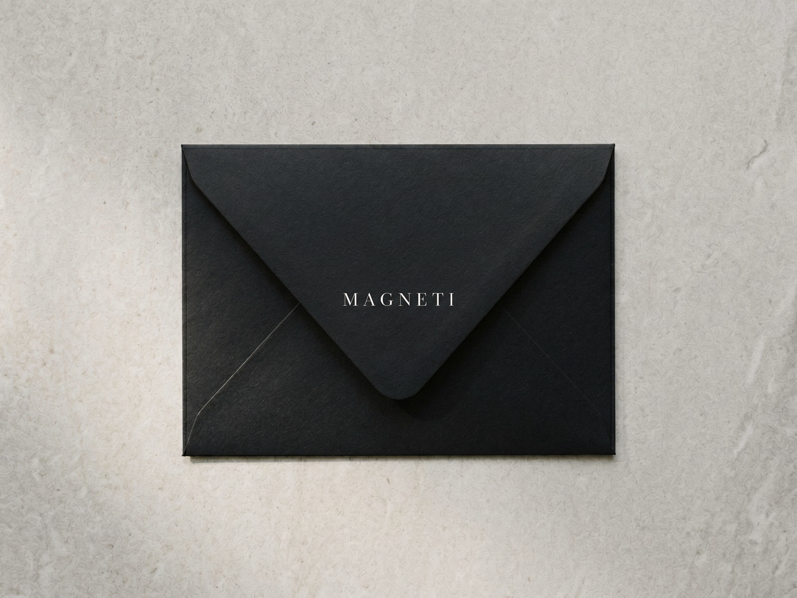 La busta nera Magneti® su pietra chiara